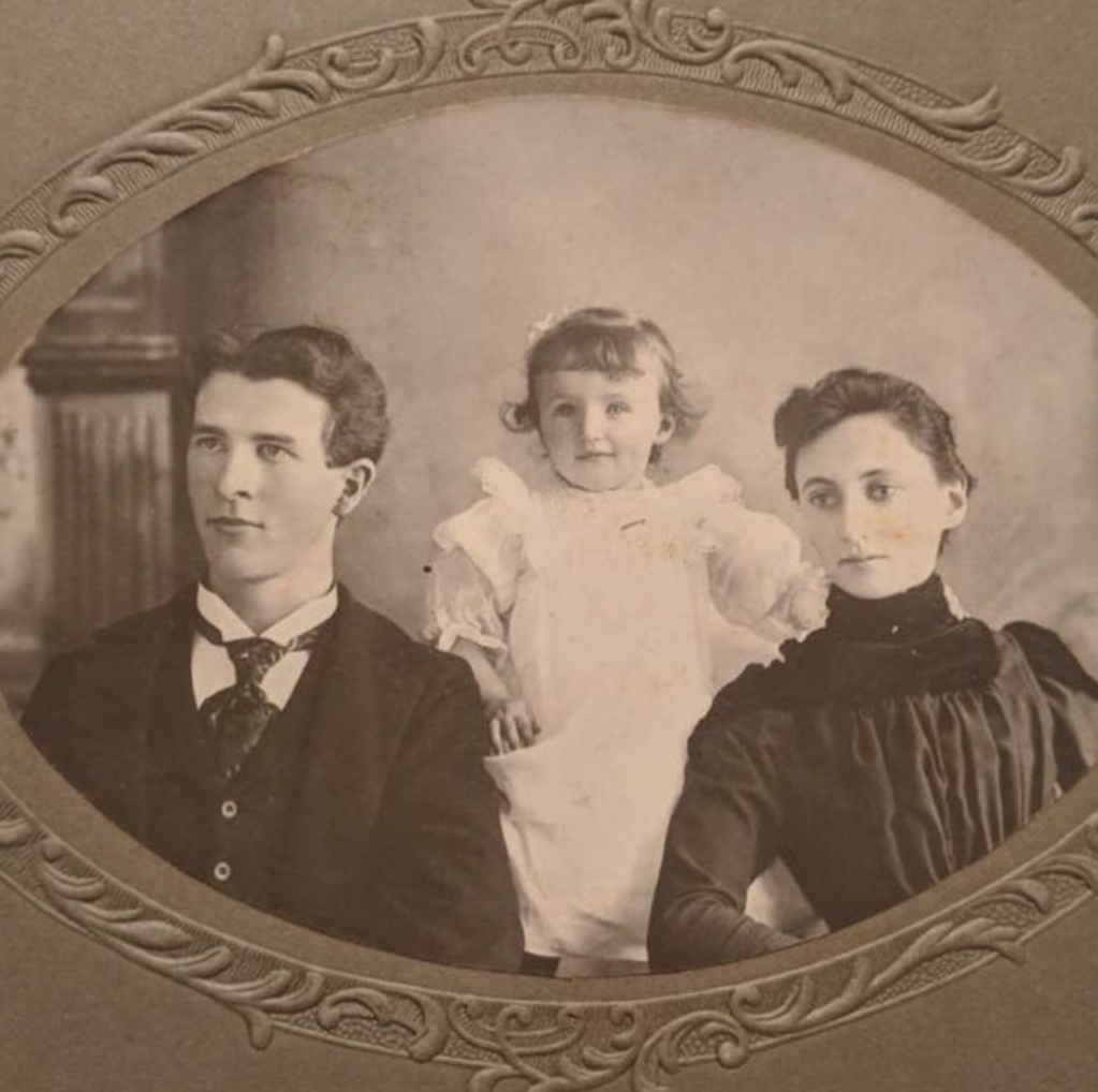 Photograph taken in 1899 featuring a young couple and a baby girl.